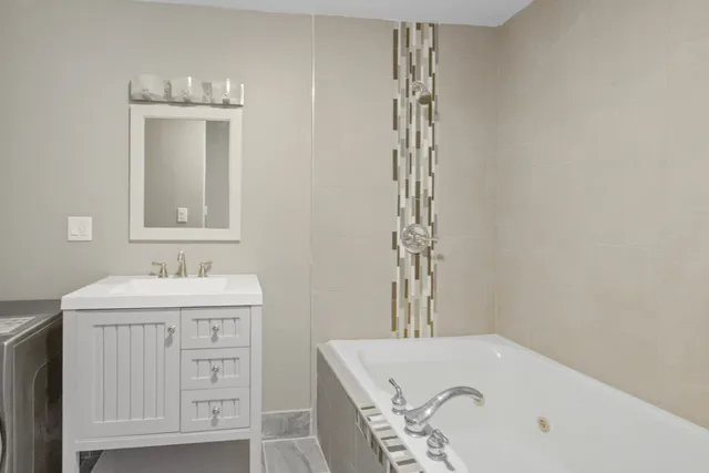 a bathroom with a sink a mirror and a bathtub