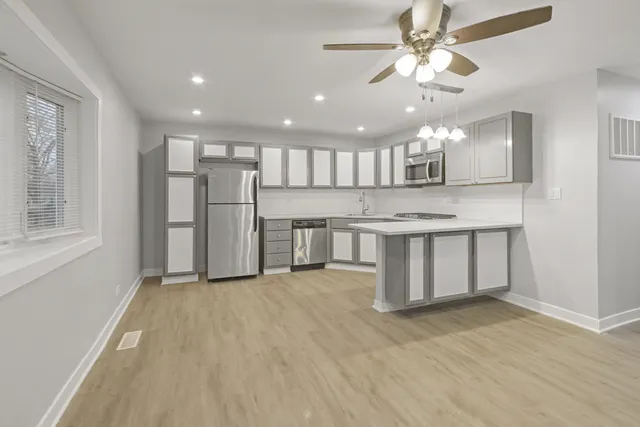 a view of a kitchen with a sink and a window