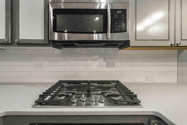 a kitchen with a stove and a microwave
