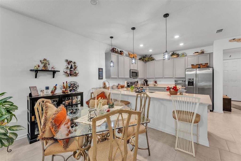 280 Pershing Street Bartow, FL 33830 - Photo 13 of 41 a kitchen with stainless steel appliances kitchen island granite countertop a table and chairs in it