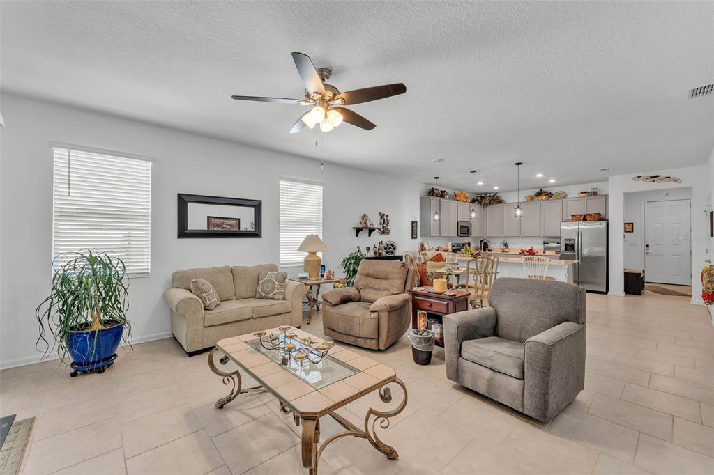 280 Pershing Street Bartow, FL 33830 - Photo 17 of 41 a living room with furniture a chandelier and a window