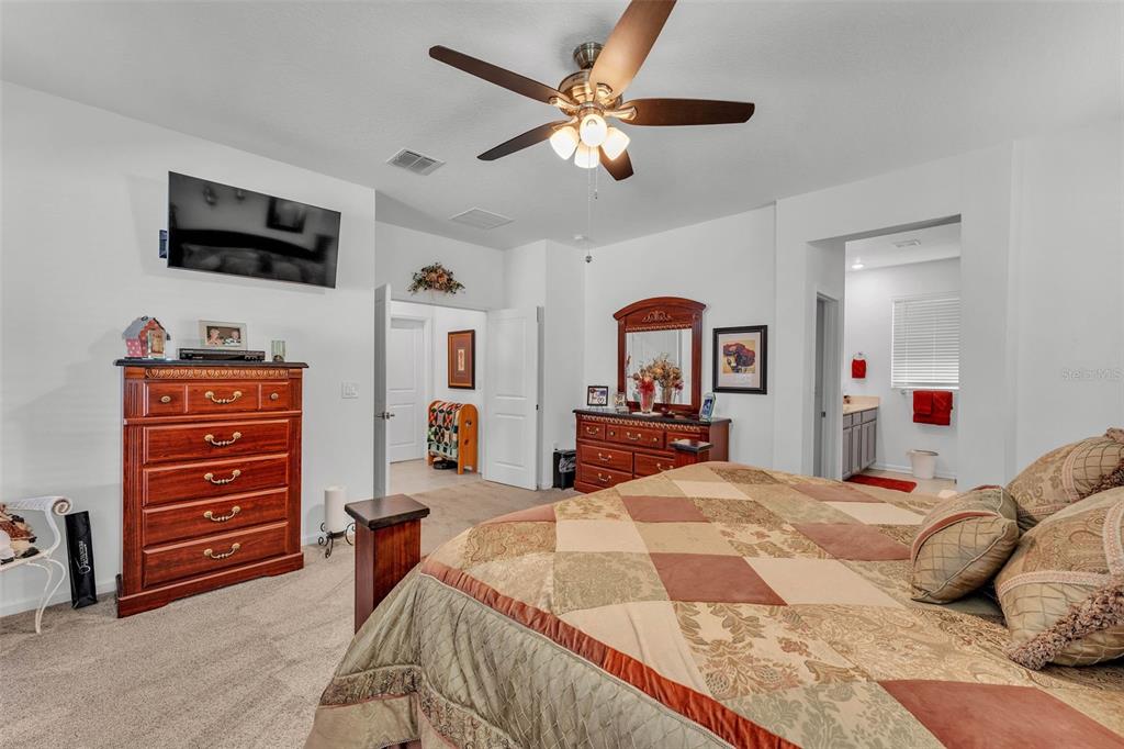 280 Pershing Street Bartow, FL 33830 - Photo 21 of 41 a bedroom with a bed dresser and flat screen tv