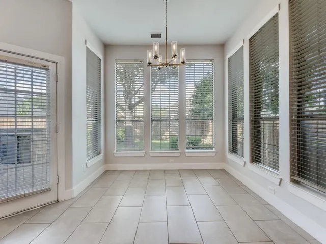 a view of an empty room with glass door