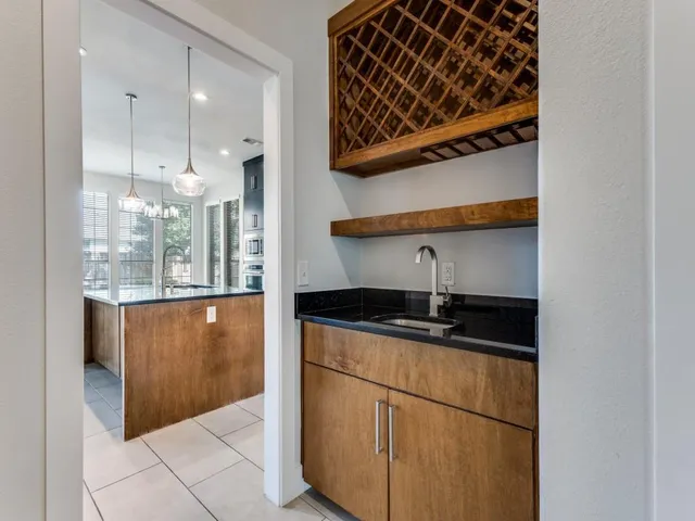 a kitchen with granite countertop a sink and a stove