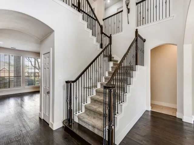 a view of entryway with wooden floor and front door