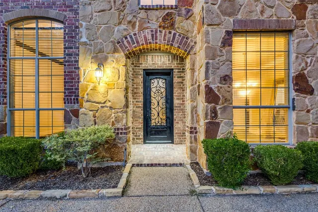 a front view of a building with a garden