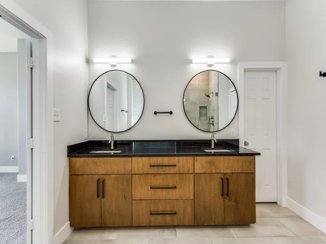 a bathroom with mirror and fan