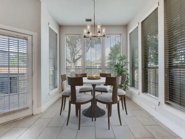 a view of a dining room with furniture large windows and wooden floor