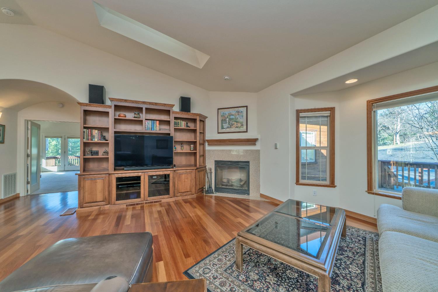 6510 Sly Park Road Placerville, CA 95667 - Photo 11 of 50 a living room with furniture a flat screen tv and a fireplace