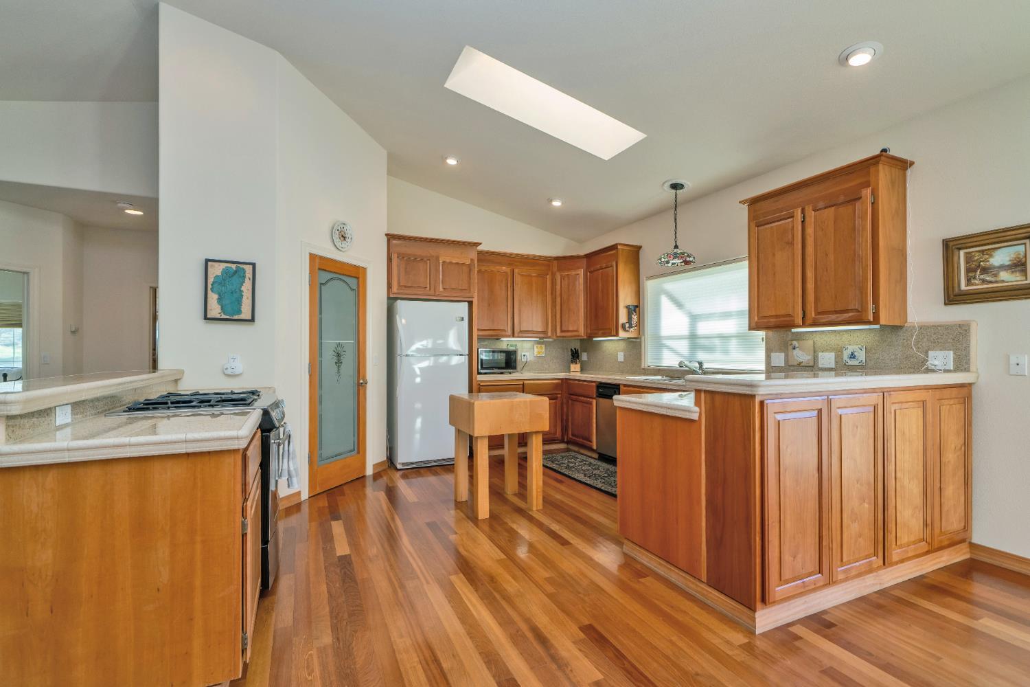 6510 Sly Park Road Placerville, CA 95667 - Photo 17 of 50 a kitchen with stainless steel appliances granite countertop a refrigerator a sink dishwasher and a stove with wooden floor
