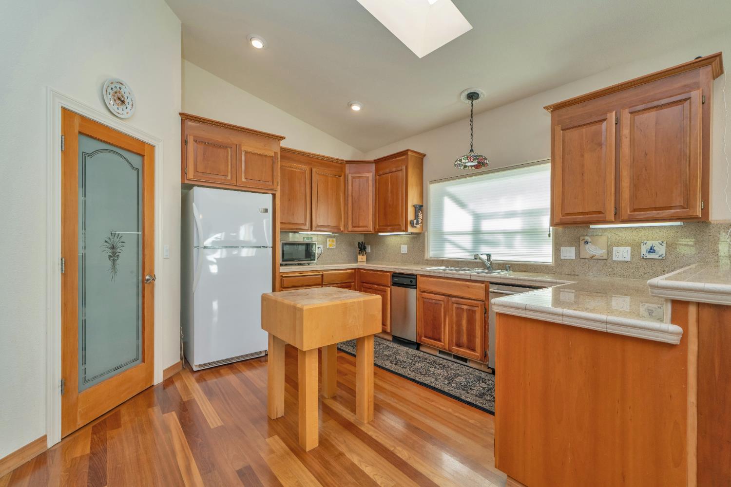 6510 Sly Park Road Placerville, CA 95667 - Photo 18 of 50 a kitchen with stainless steel appliances granite countertop a refrigerator a sink dishwasher a stove with wooden cabinets and floor