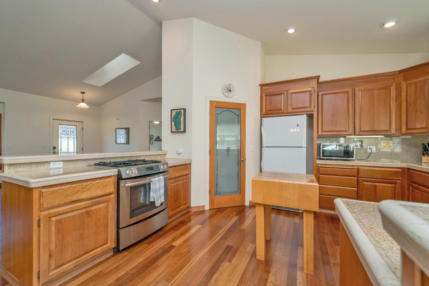 6510 Sly Park Road Placerville, CA 95667 - Photo 19 of 50 a kitchen with stainless steel appliances granite countertop a refrigerator a stove and a sink with wooden floors