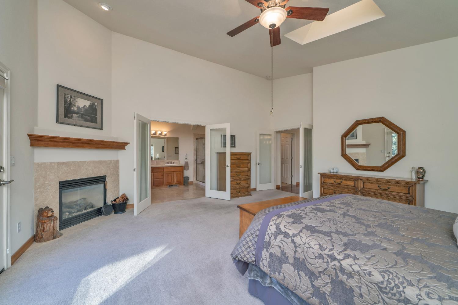 6510 Sly Park Road Placerville, CA 95667 - Photo 23 of 50 a bedroom with a large bed and a fireplace