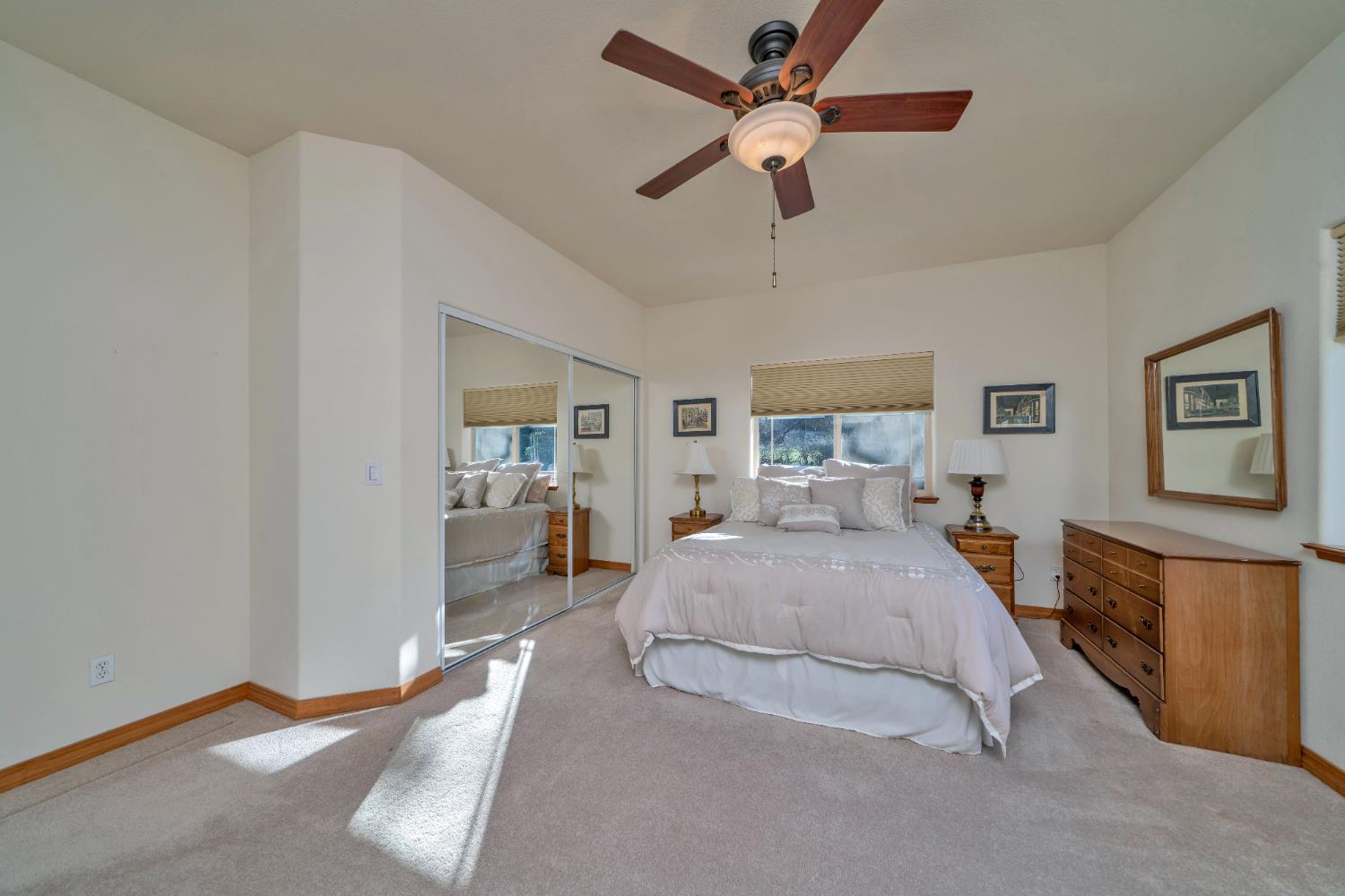 6510 Sly Park Road Placerville, CA 95667 - Photo 31 of 50 a spacious bedroom with a bed and a chandelier