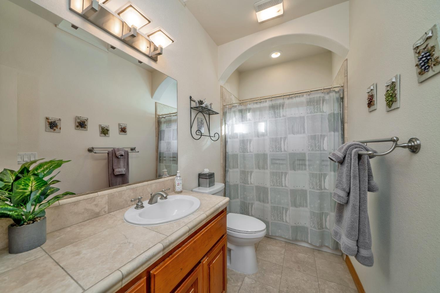 6510 Sly Park Road Placerville, CA 95667 - Photo 32 of 50 a bathroom with a granite countertop sink a toilet and shower