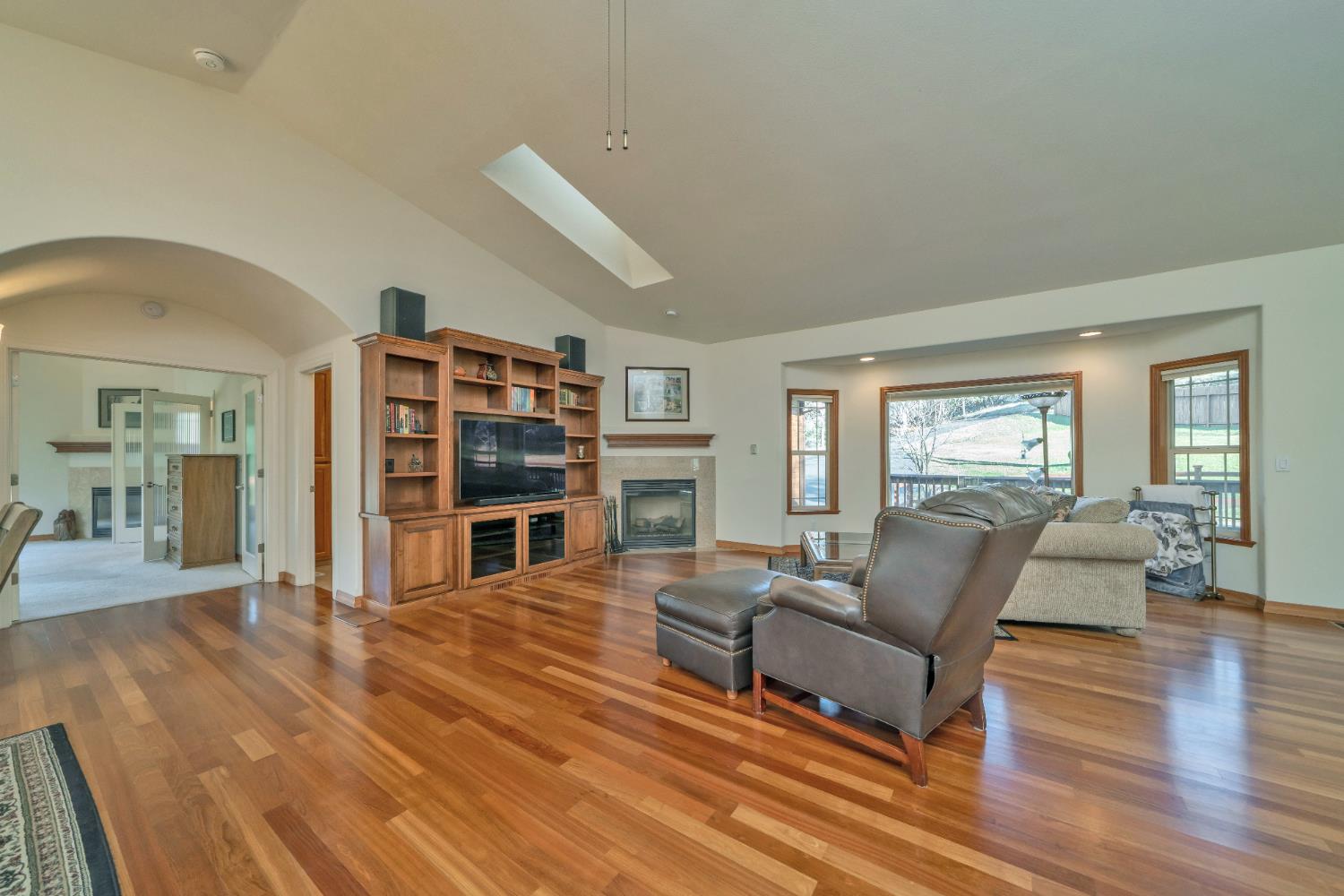 6510 Sly Park Road Placerville, CA 95667 - Photo 10 of 50 a living room with furniture a fireplace and a flat screen tv