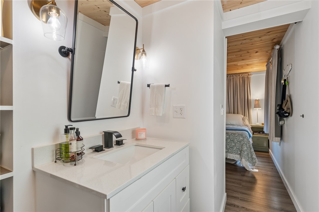 30 Mobleys Bluff Road Abbeville, SC 29620 - Photo 18 of 35 Natural wood ceilings complement the clean white finishes of this updated bathroom vanities and entryway.
