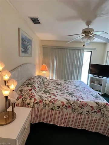 a bedroom with a bed and a lamp