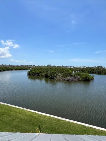 a view of a lake with houses in the back