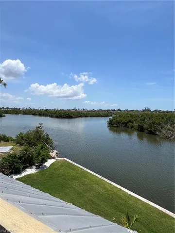 a view of a lake with houses in the back