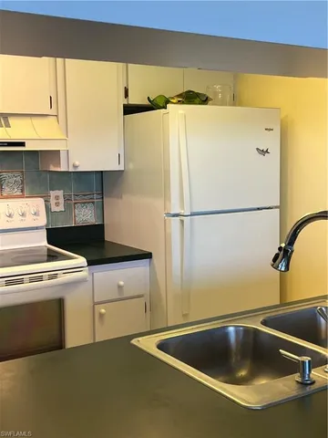 a view of a kitchen with a sink and dishwasher