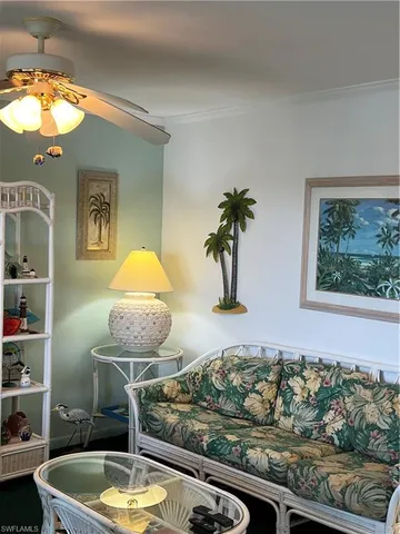 a living room with furniture and a potted plant
