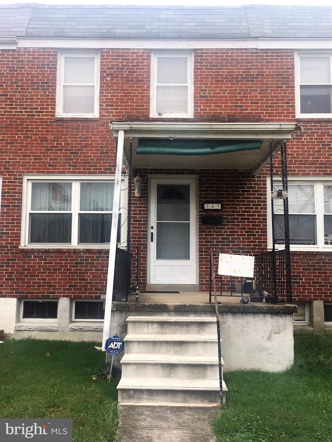 745 Aldworth Road Baltimore, MD 21222 - Photo 1 of 11 a front view of a house with a garden and plants