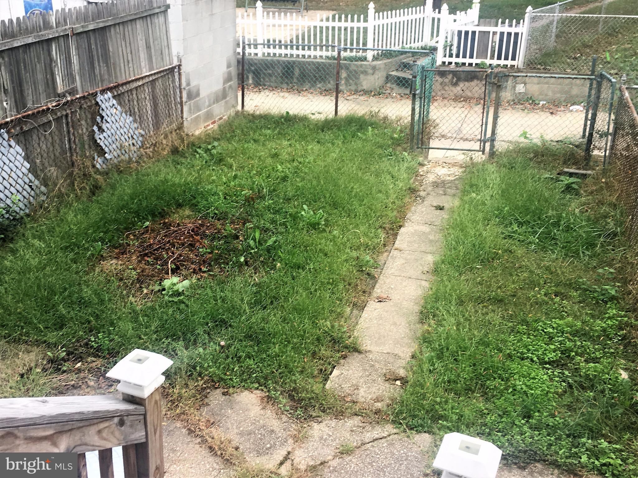 745 Aldworth Road Baltimore, MD 21222 - Photo 11 of 11 a view of backyard with a garden and plants
