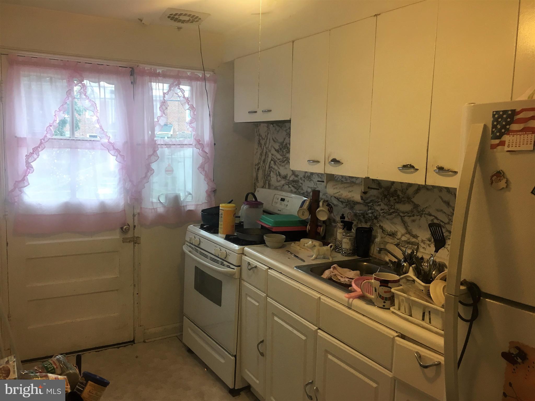 745 Aldworth Road Baltimore, MD 21222 - Photo 6 of 11 a kitchen with a stove and a window