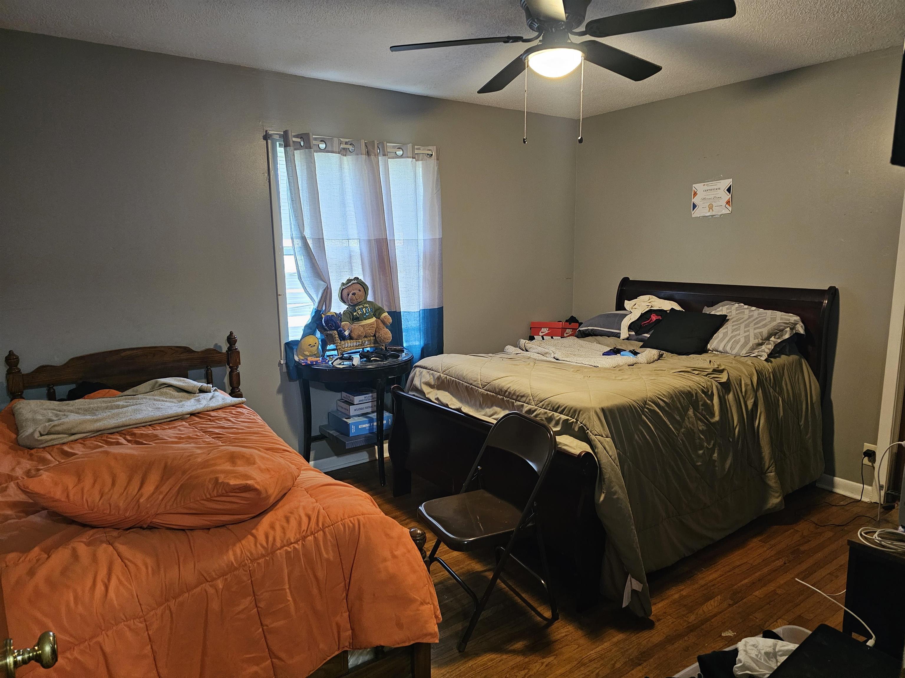 488 Perkins Street Ripley, TN 38063 - Photo 12 of 23 a bedroom with a bed and a chandelier