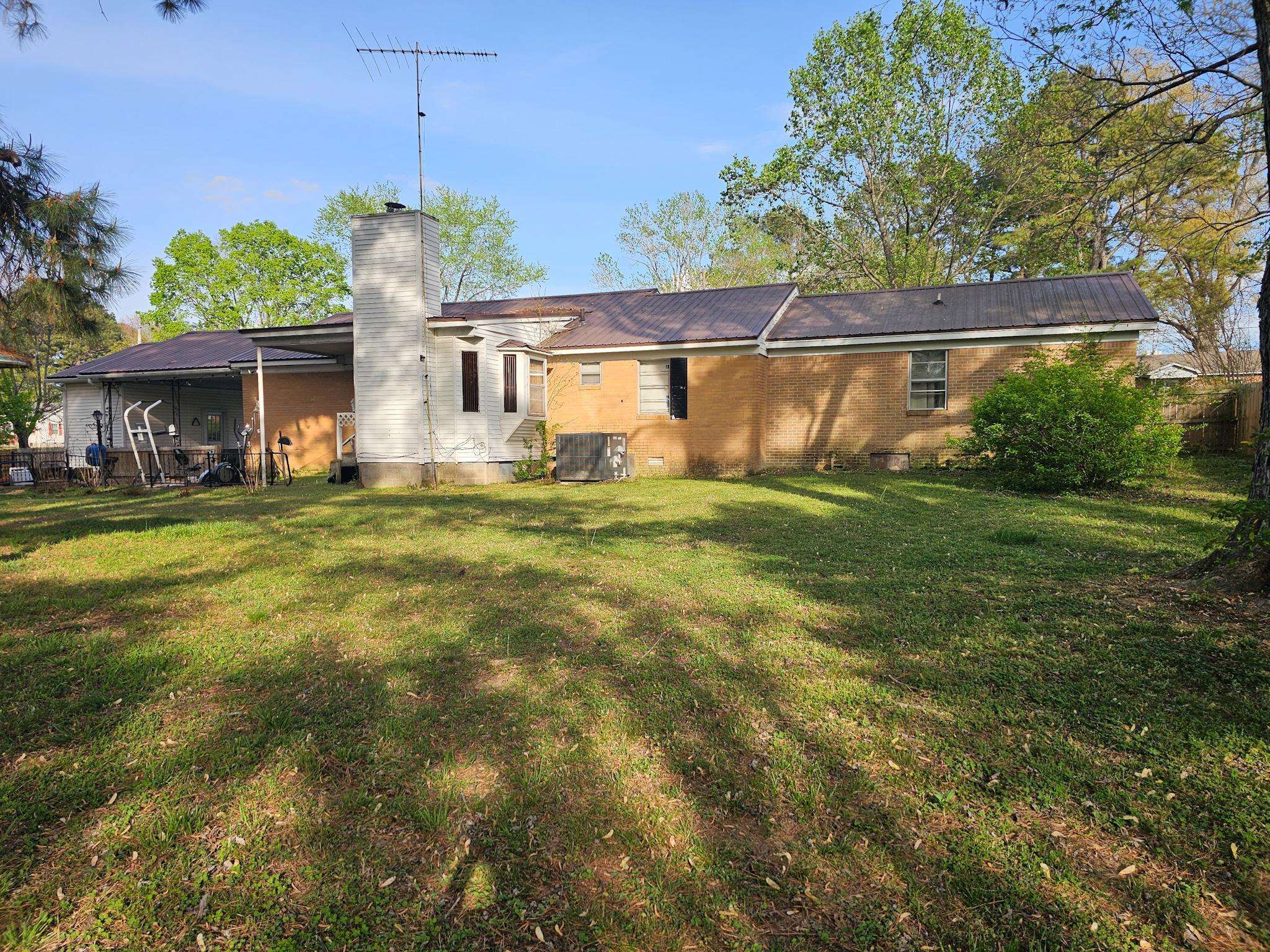 488 Perkins Street Ripley, TN 38063 - Photo 20 of 23 a view of a house with a big yard and a large tree