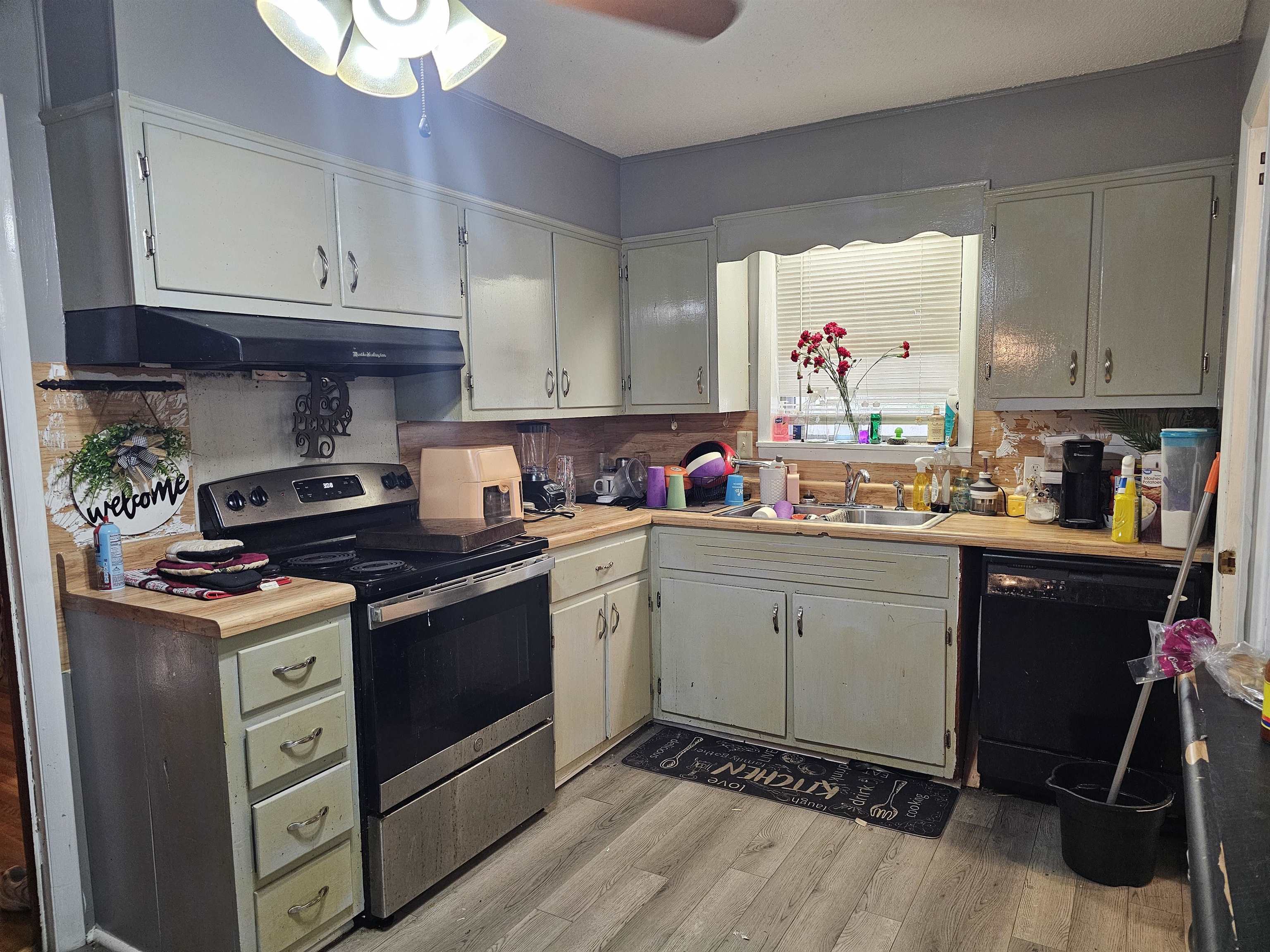 488 Perkins Street Ripley, TN 38063 - Photo 3 of 23 a kitchen with a stove a sink and cabinets