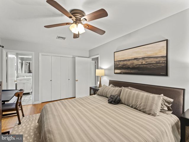 a bedroom with a large bed and a large window