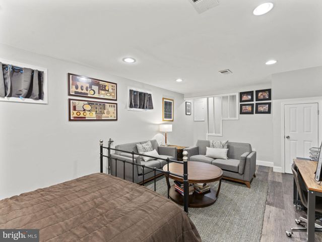 a living room with furniture and paintings on the wall