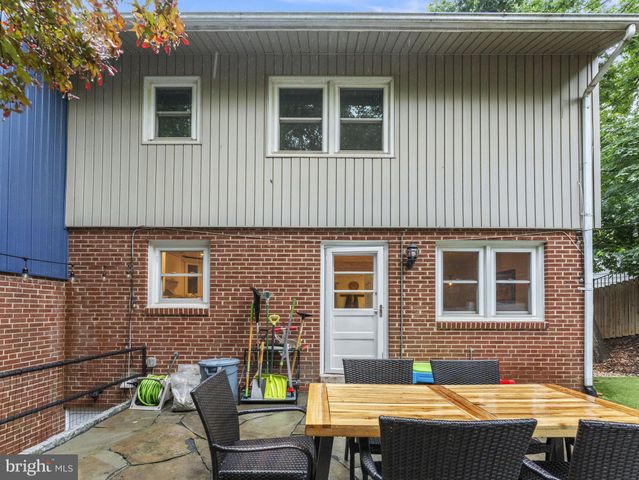 a view of a house with a wooden fence