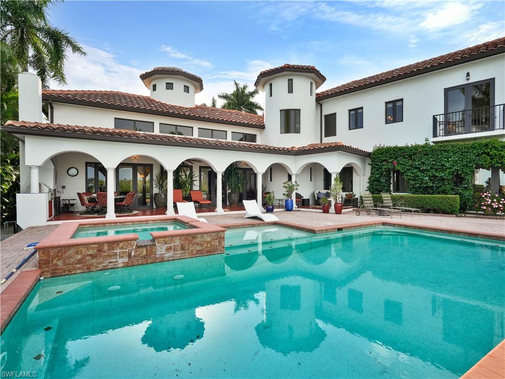 2535 Tarpon Road Naples, FL 34102 - Photo 44 of 50 Mediterranean-style residence featuring a tile roof, stucco exterior, multiple balconies, and a private dock