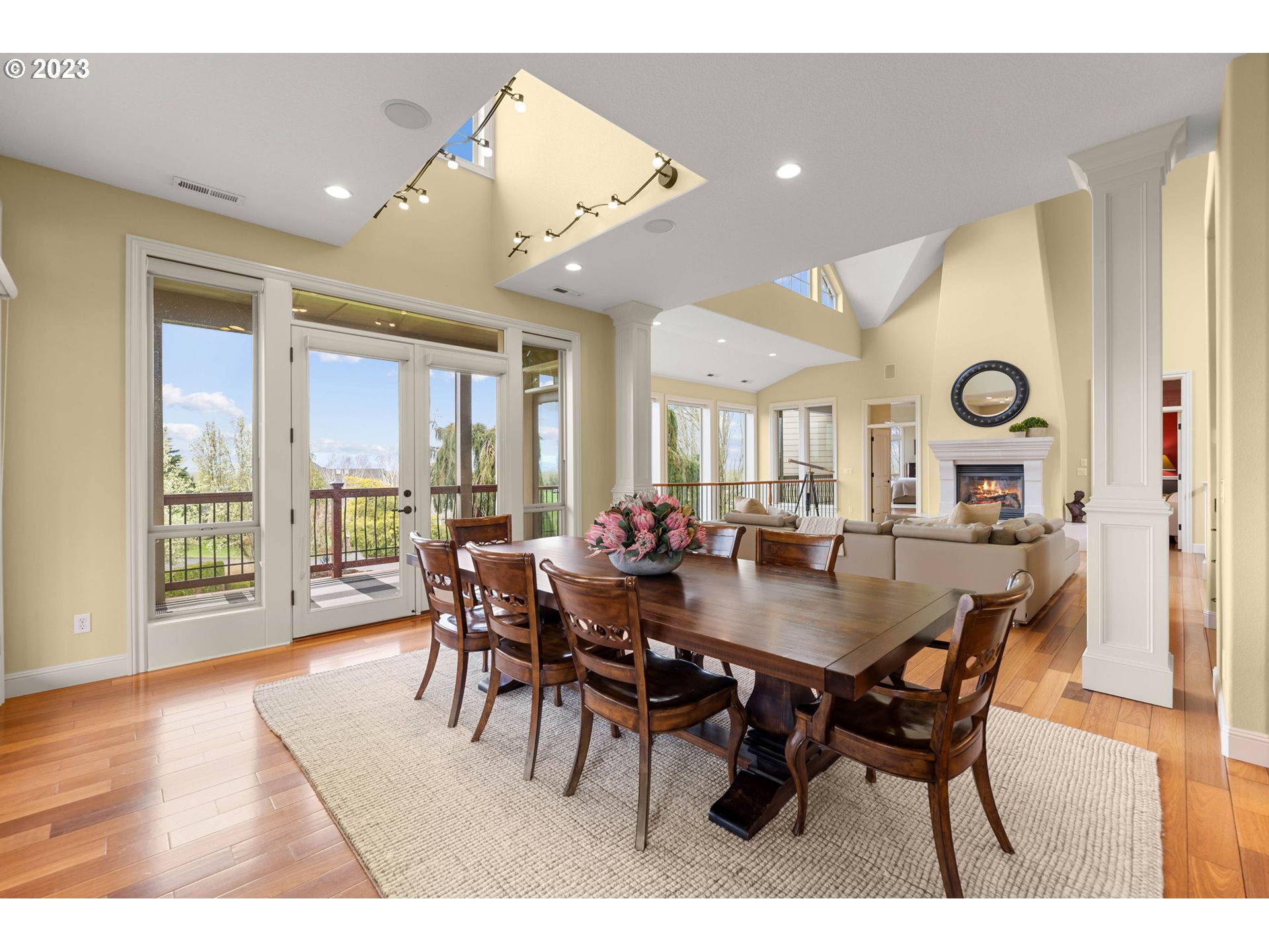 6405 Northwest 202nd Circle Ridgefield, WA 98642 - Photo 19 of 45 a view of a dining room and livingroom with furniture wooden floor and a rug
