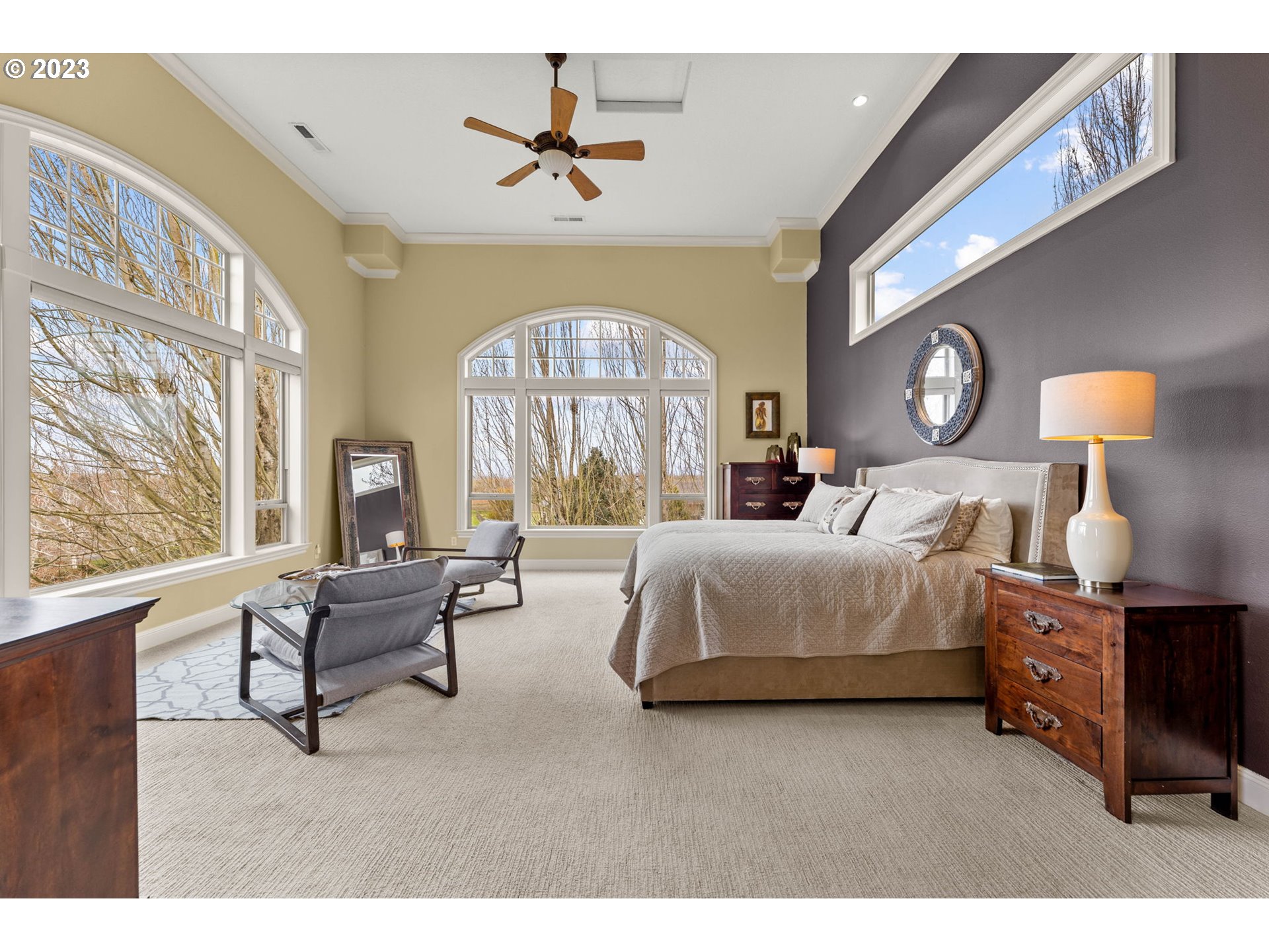 6405 Northwest 202nd Circle Ridgefield, WA 98642 - Photo 24 of 45 a bedroom with a bed and a chandelier