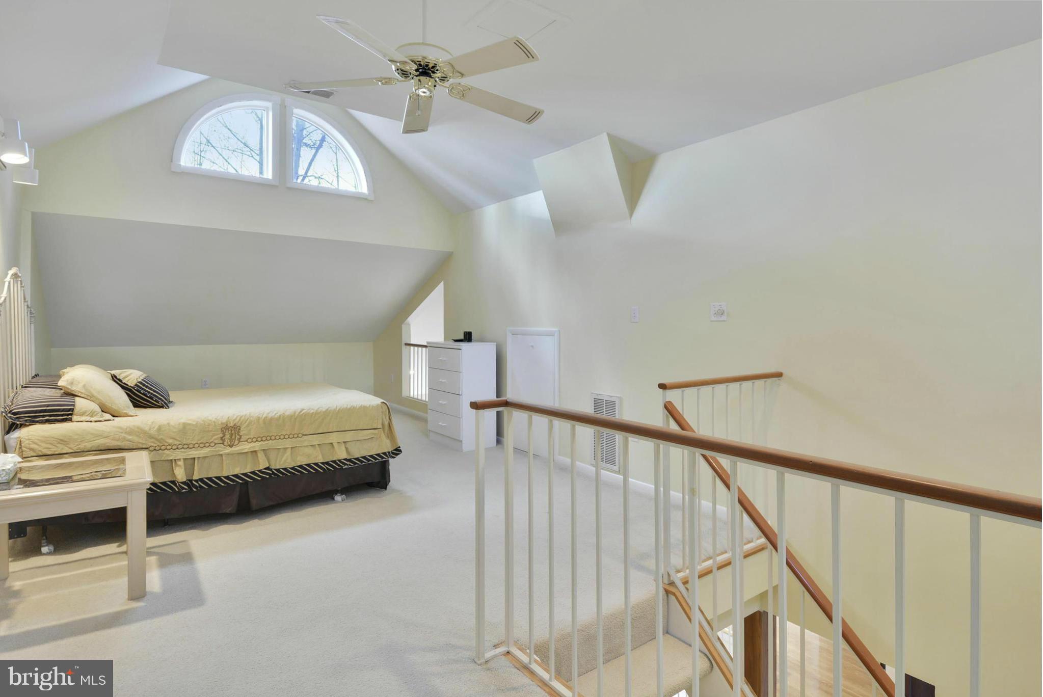 11256 Oakton Road Oakton, VA 22124 - Photo 18 of 29 a spacious bedroom with a bed and a chandelier