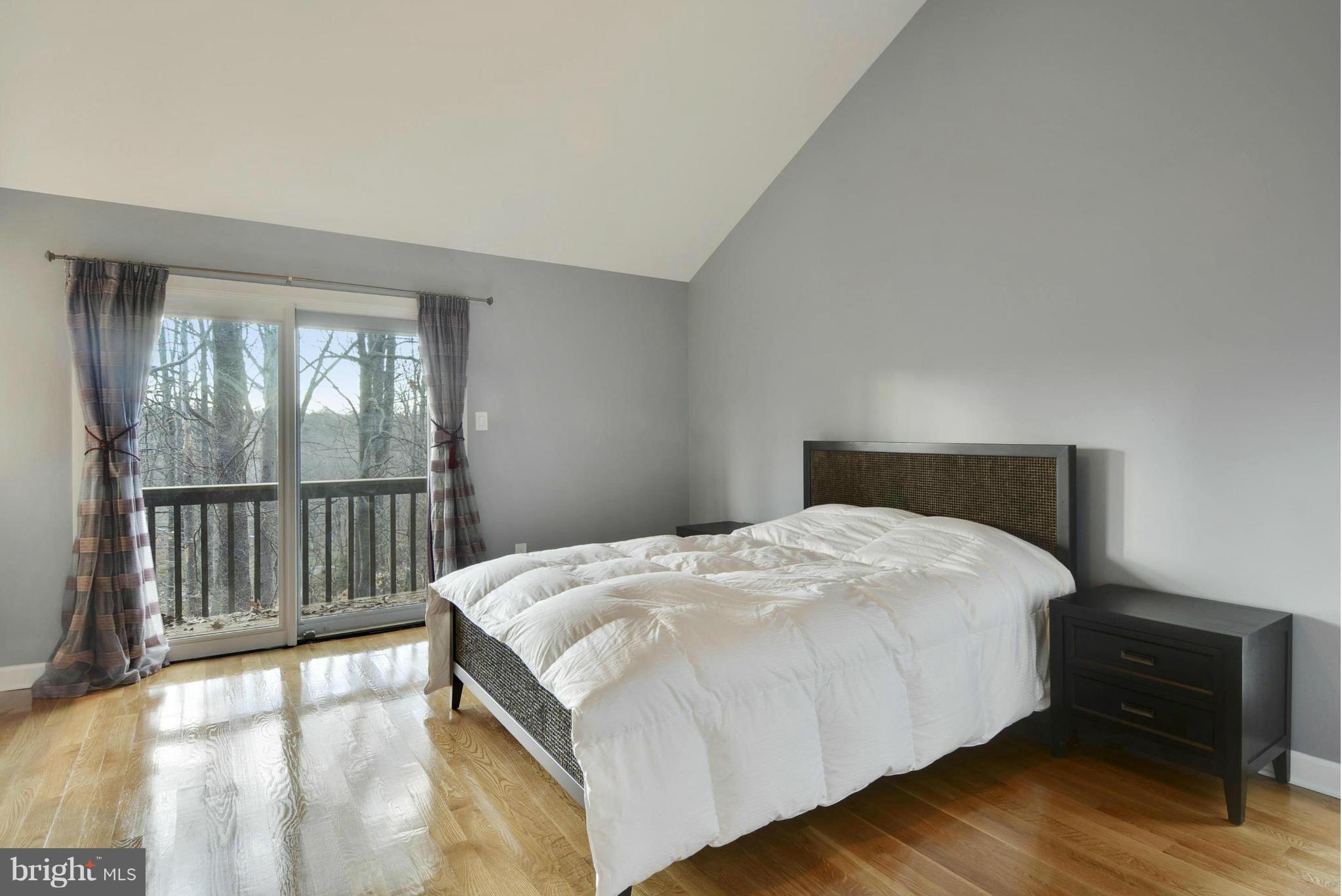 11256 Oakton Road Oakton, VA 22124 - Photo 10 of 29 a bedroom with a bed and wooden floor