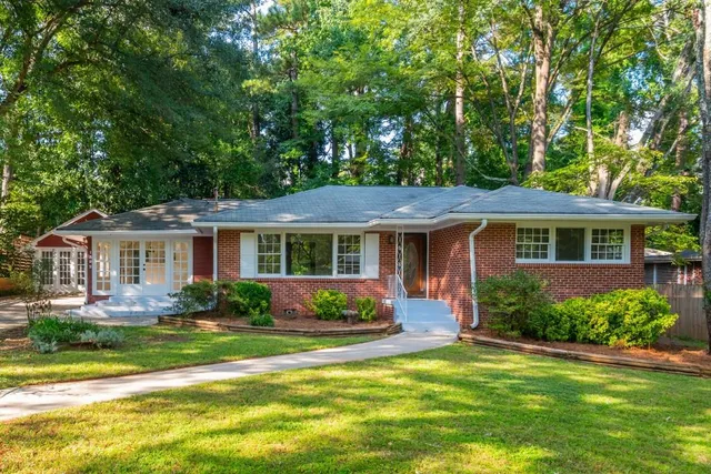 a front view of a house with garden