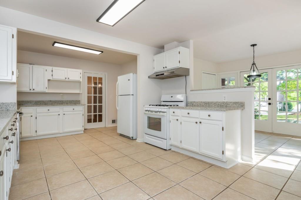 1392 Lively Ridge Road Northeast Atlanta, GA 30329 - Photo 17 of 42 a kitchen with cabinets and window