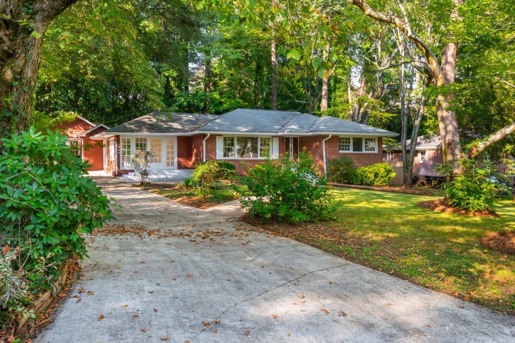 1392 Lively Ridge Road Northeast Atlanta, GA 30329 - Photo 3 of 42 a front view of a house with a garden
