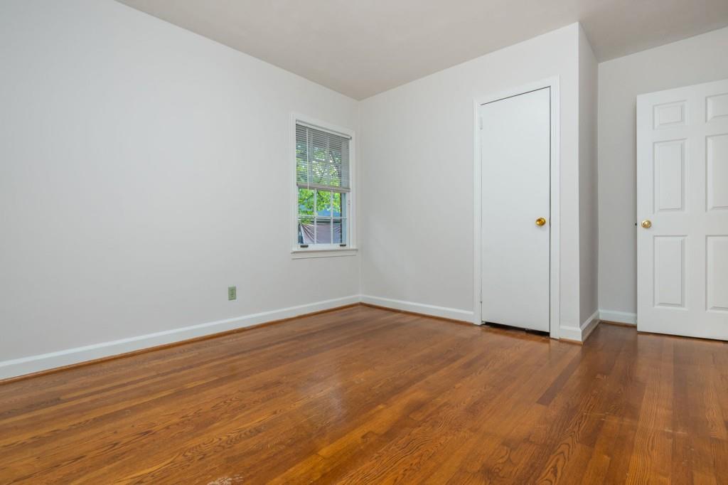 1392 Lively Ridge Road Northeast Atlanta, GA 30329 - Photo 32 of 42 an empty room with wooden floor and windows