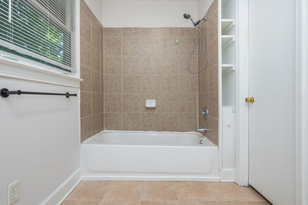 1392 Lively Ridge Road Northeast Atlanta, GA 30329 - Photo 35 of 42 a white bath tub sitting next to a shower