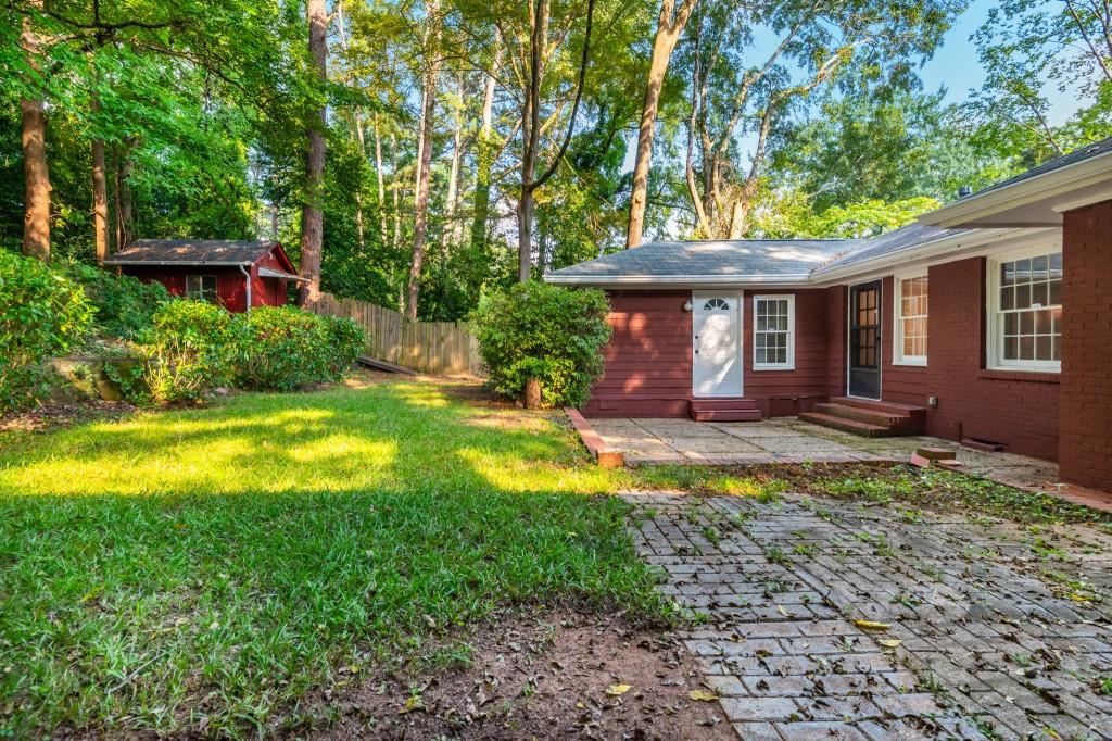 1392 Lively Ridge Road Northeast Atlanta, GA 30329 - Photo 38 of 42 a view of a house with swimming pool and yard