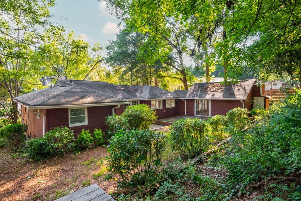 1392 Lively Ridge Road Northeast Atlanta, GA 30329 - Photo 41 of 42 a view of brick house with a yard and potted plants