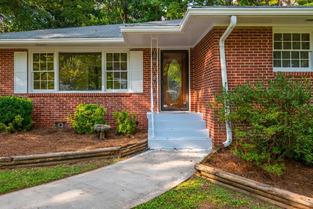 1392 Lively Ridge Road Northeast Atlanta, GA 30329 - Photo 5 of 42 a front view of a house with a yard