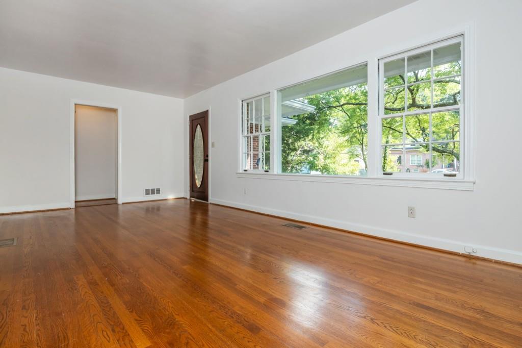 1392 Lively Ridge Road Northeast Atlanta, GA 30329 - Photo 6 of 42 a view of empty room with wooden floor and fan