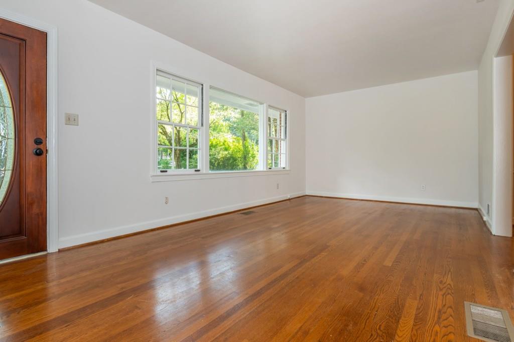 1392 Lively Ridge Road Northeast Atlanta, GA 30329 - Photo 8 of 42 an empty room with wooden floor and windows
